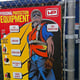 Construction safety signage attached to a chainlink fence.