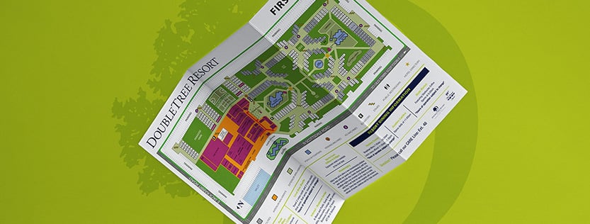 mockup of a z-fold map brochure on a green background for doubletree resort by hilton.