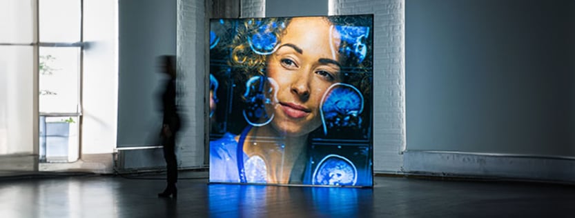A backlit fabric display featuring a woman's face as the graphic.