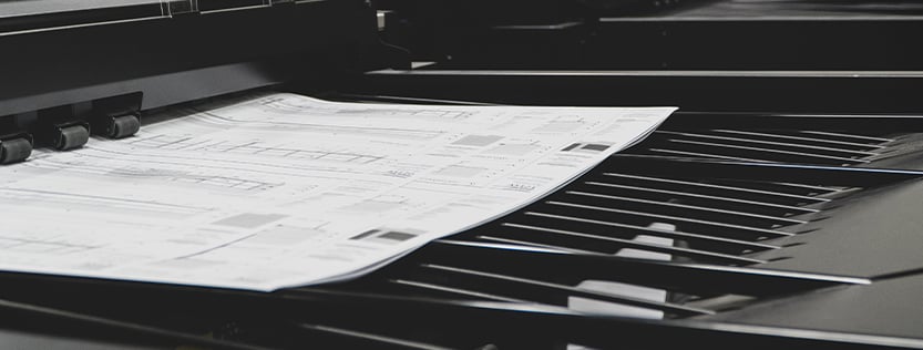 Black and white construction documents being printed.