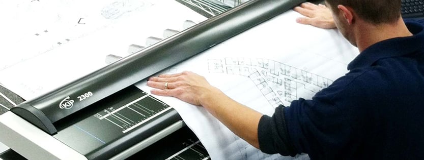 A print associate scanning blueprints.