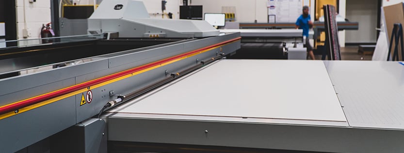 large-format flatbed printer in a commercial print facility.
