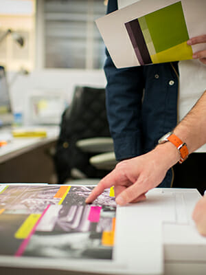 A person checking the color on a recent print job.