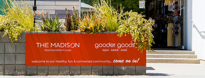 custom printed orange store signage for the madison and gooder goods.