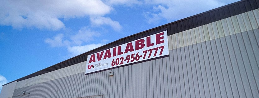 Commercial real estate banner hung on a warehouse.