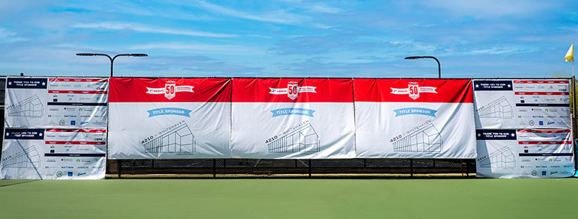 Large fence banners in a pickleball court.