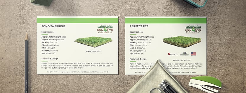 Two post cards for the turf company GRN 4 EVR featured on a concrete table.
