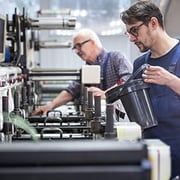 2 men working at a latex printer