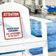 Lifeguard char beside pool with No Lifeguard on Duty warning sign
