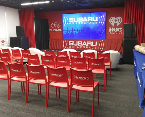 Subaru Soundspace convention with graphics printed on chairs and stage backdrop