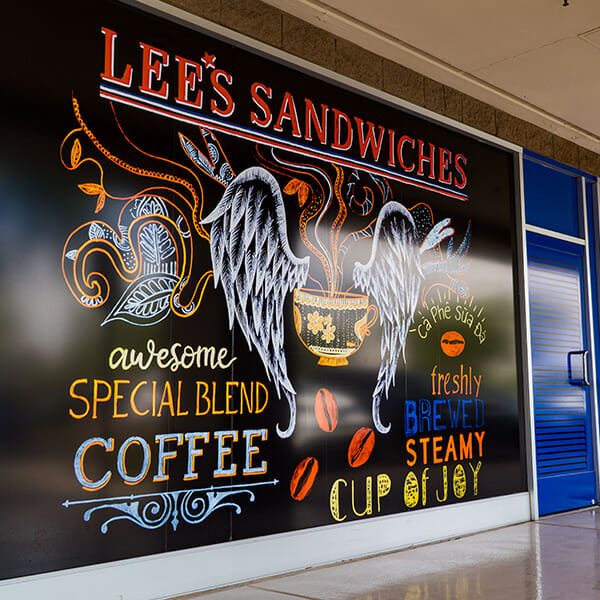 Large printed wall signage for Lee's Sandwiches.