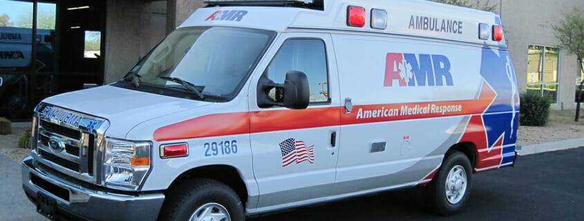 medical ambulance with branded graphics packed outside of building