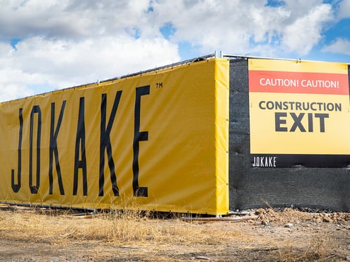 Vinyl fence banner wrap and construction sign for Jokake Construction.