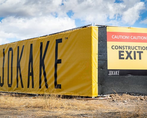 Vinyl fence banner wrap and construction sign for Jokake Construction.