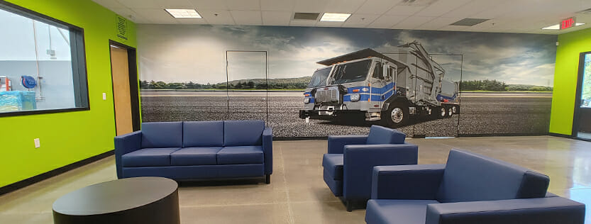 Full wall mural showing large industrial vehicle in an open field.