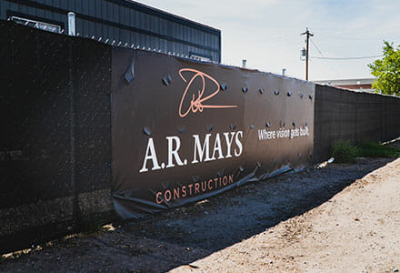 Construction fence wrap banner with cut wind slits for AR Mays.