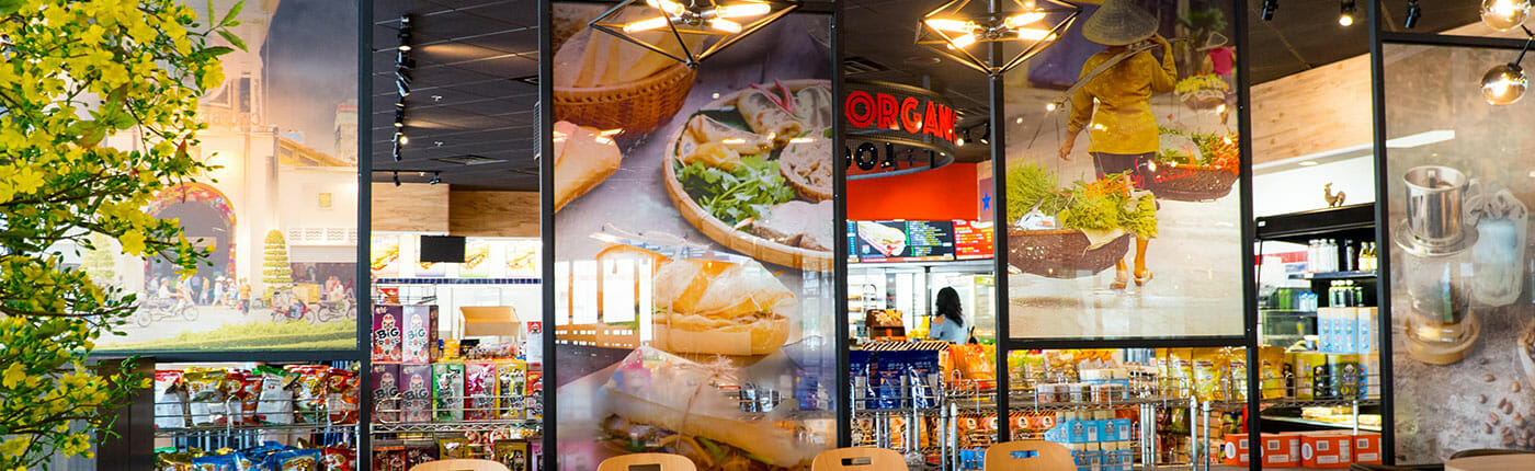Printed clear acrylic panel displays in a organic market cafe.