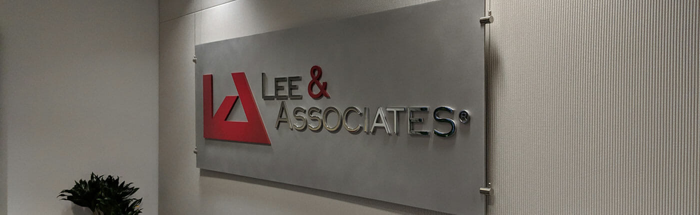 Office lobby sign for commercial real estate company Lee & Associates.