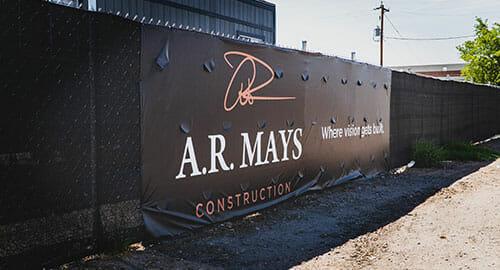 Construction fence wrap banner with cut wind slits for AR Mays.