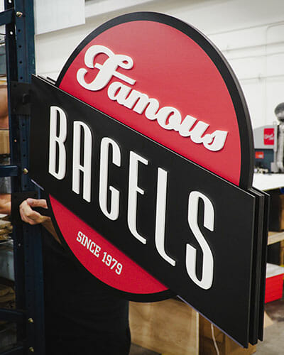 Dimensional blade sign promoting famous bagels for Chompies restaurants.