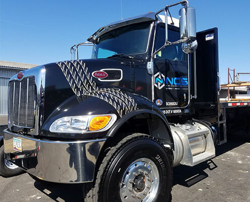 Vinyl graphics on the side and hood of a semi-truck for NCS Construction Supply