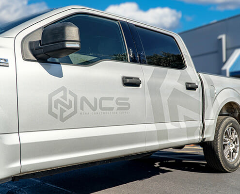 Ghosted vinyl graphics on the side of a truck for NCS Construction Supply