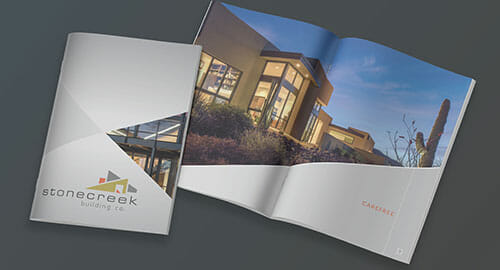 Saddle-stitch brochures showcasing the cover and inside pages displayed on a dark grey table.