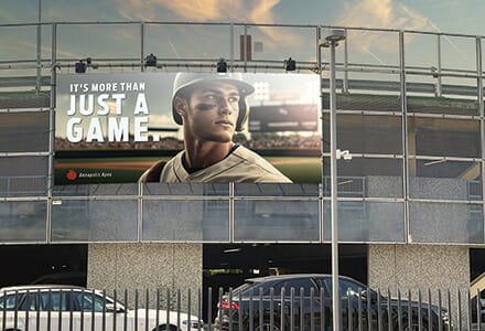 Baseball billboard on the side of a stadium of a baseball player and a phrase that says "It's more than just a game."