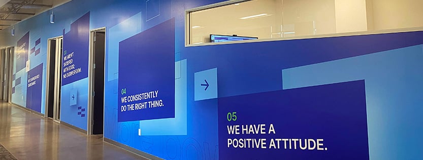 blue branded wall wrap with positive messages.