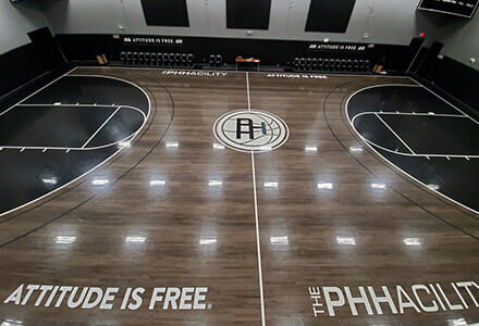 Overhead view of a basketball court with vinyl floor graphics for Attitude Is Free