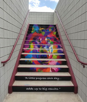 Stair riser decals of a colorful wolf head installed at a local Arizona school