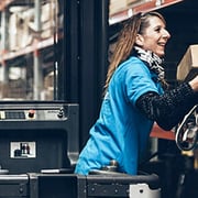 Warehouse worker stocking boxes of products onto storage shelves
