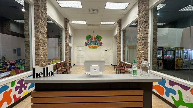 Spacious entry lobby at Central Arkansas Inflatables Indoor Park in Bryant AR featuring colorful inflatable decorations, welcome desk, and party check-in area