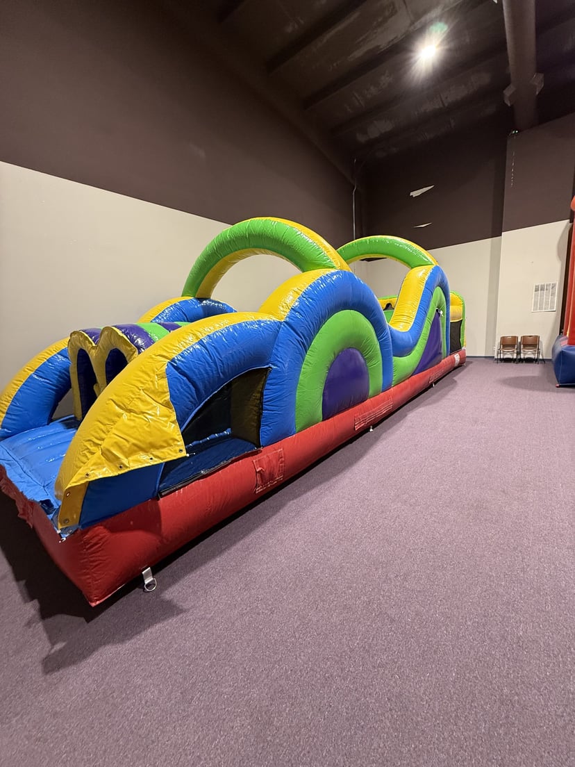 Second view of the 40ft indoor inflatable obstacle course with climbing walls and dual slide lanes in Bryant, AR