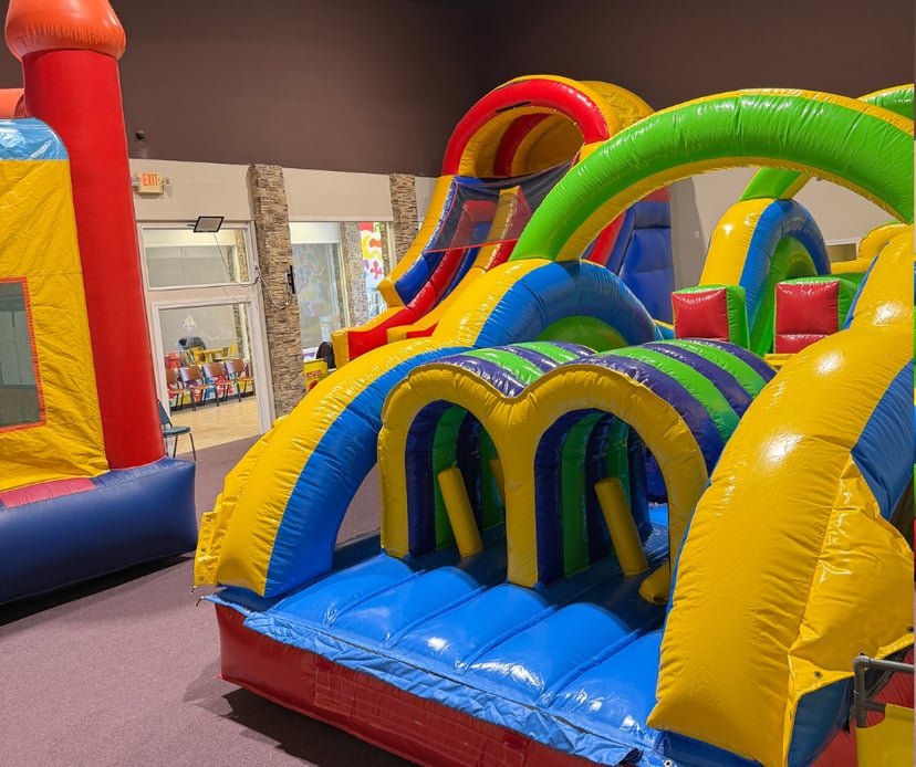 Wide view of the 40ft indoor inflatable obstacle course and open play floor at Central Arkansas Inflatables