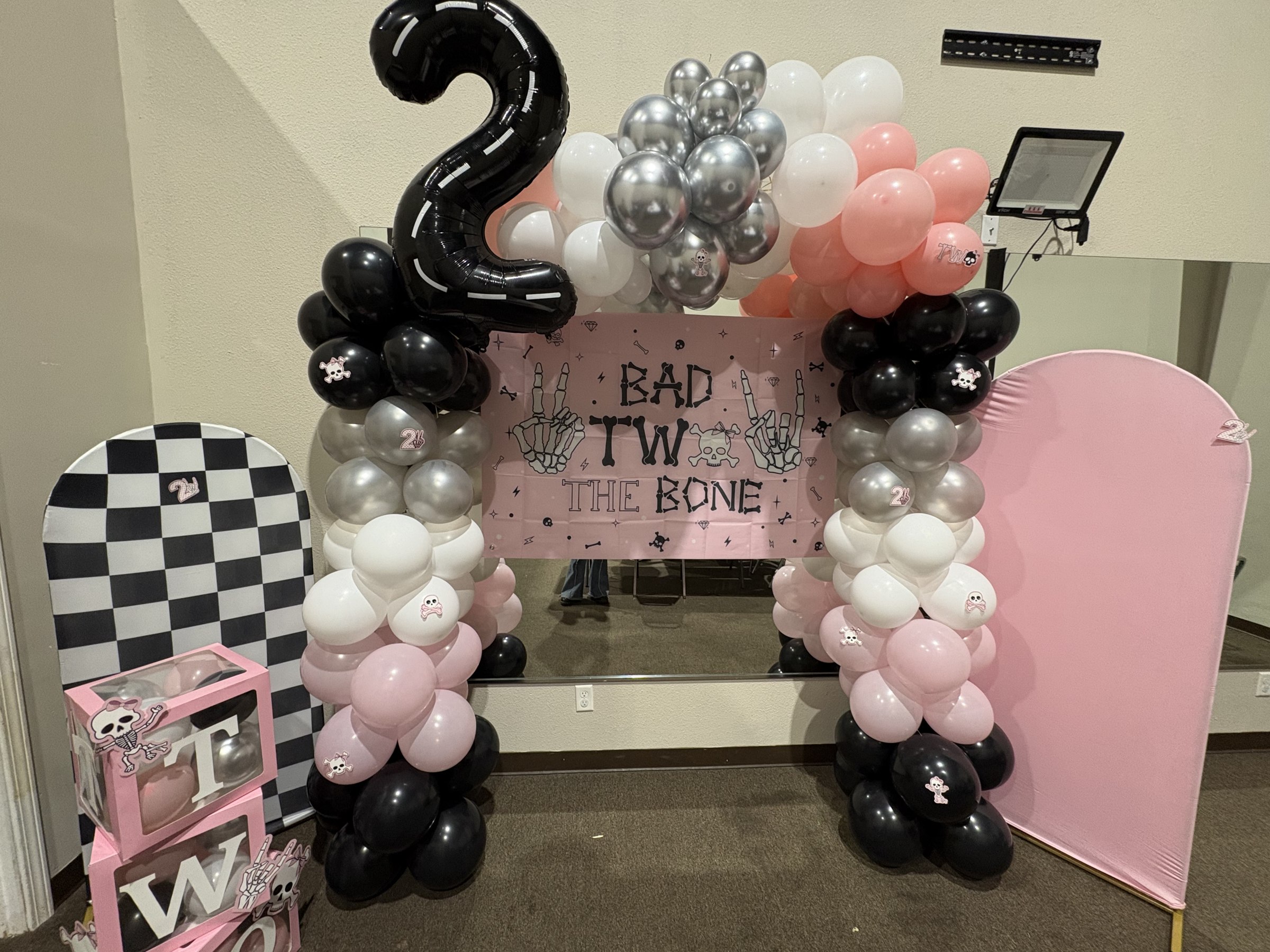 Pink and black 2nd birthday balloon arch party setup