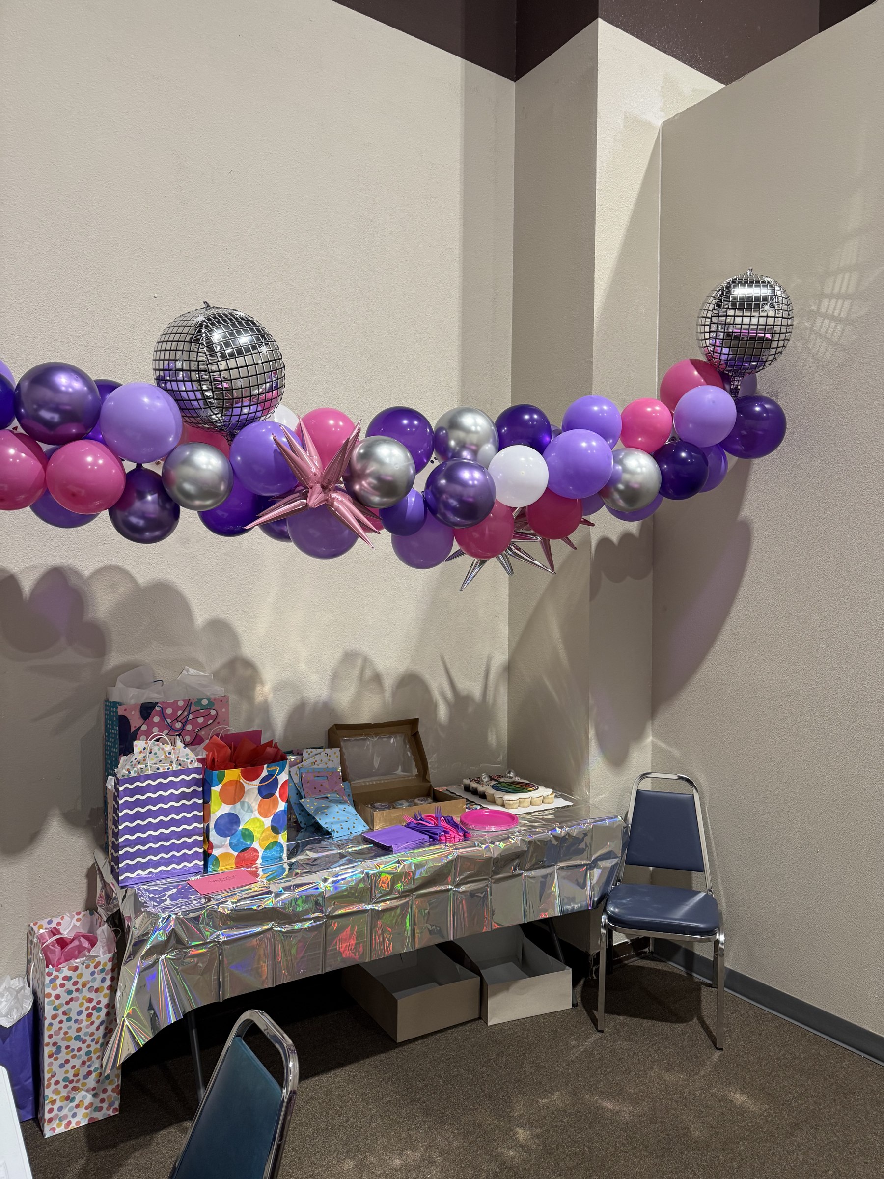 Purple and silver disco balloon garland party room setup