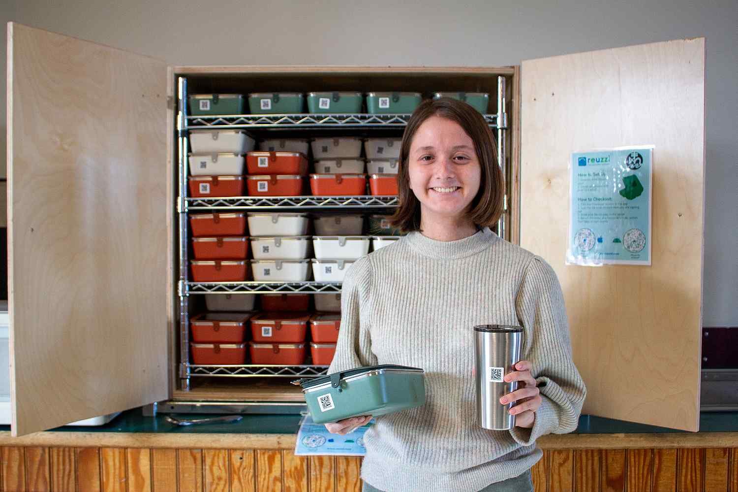Person holding reusable containers and cup.