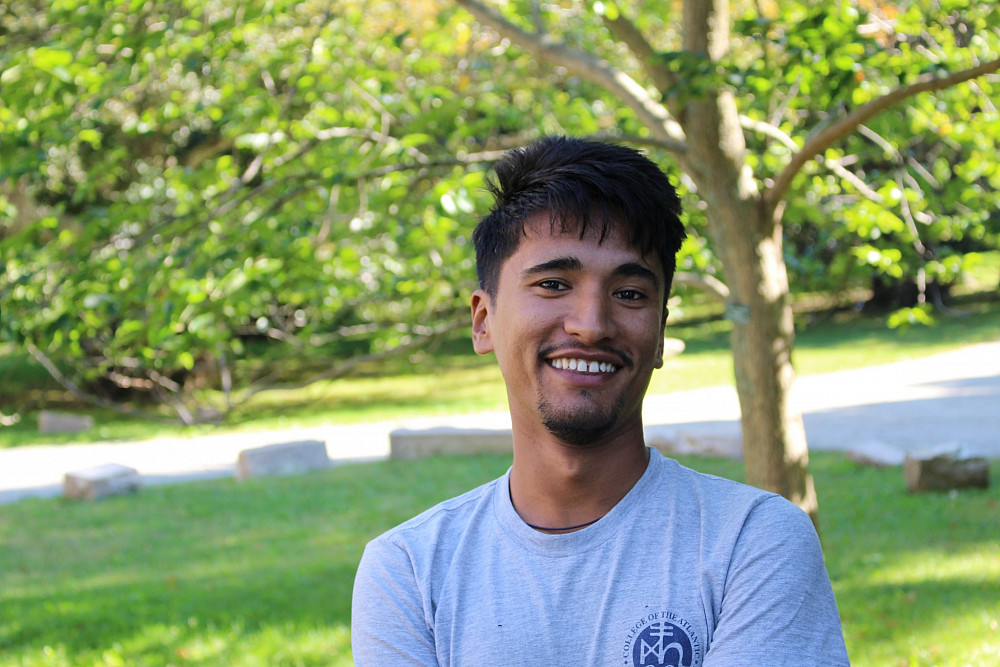 Person standing in a green park.