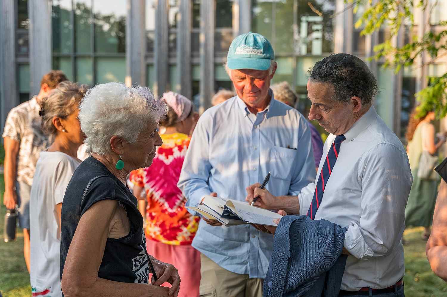People interacting at an outdoor event.