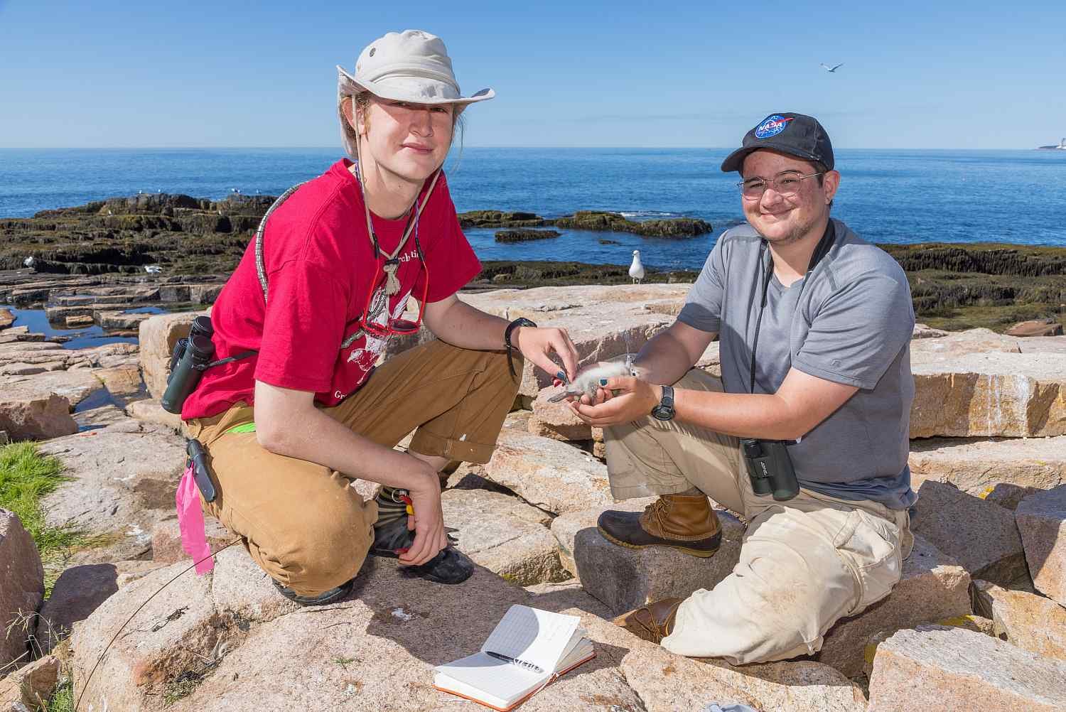 Watson Fellowship awardee Wriley Hodge ’24, left, banding birds at the COA Alice Eno Field Resear...