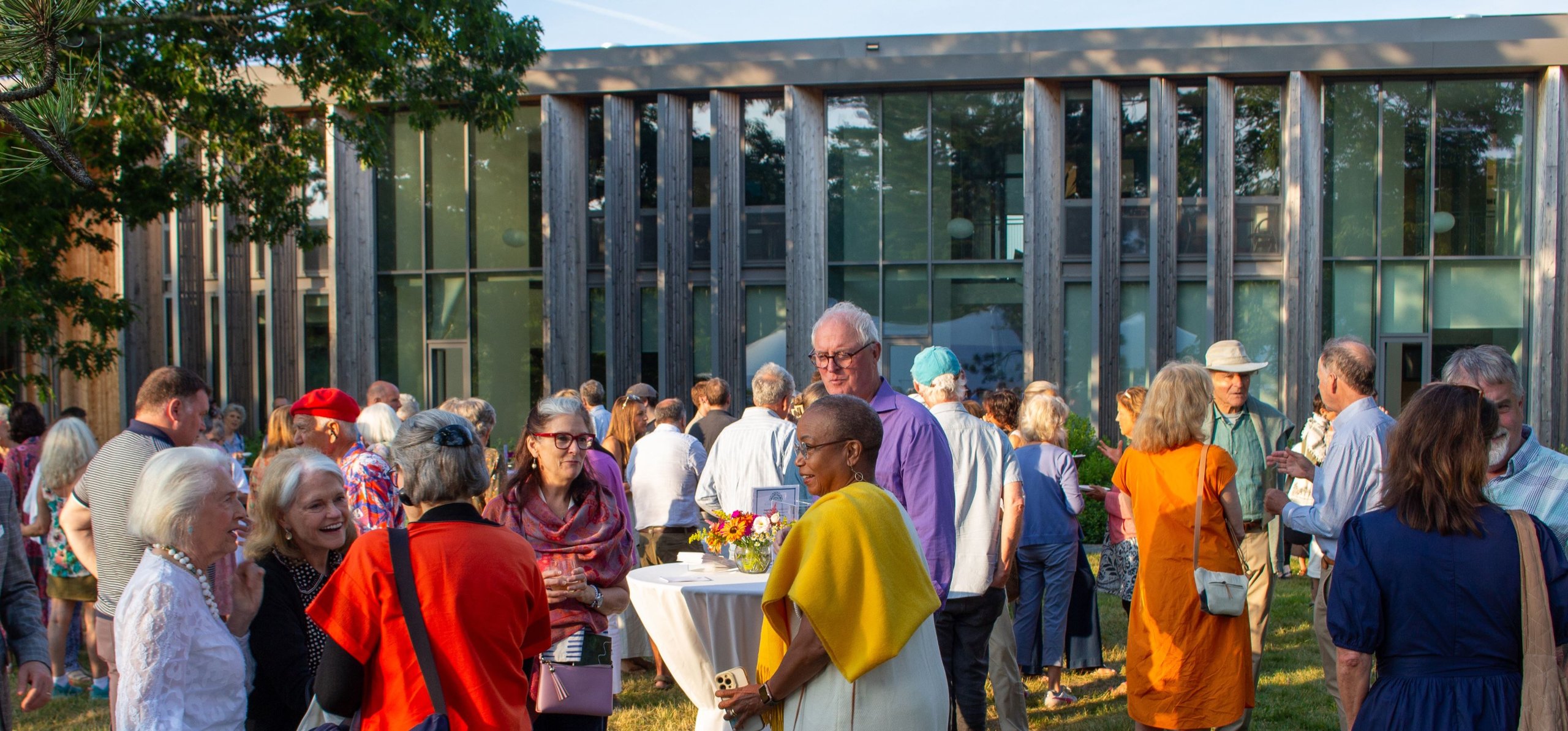 people gathered in front of Davis Center for Human Ecology for a summer cocktail party