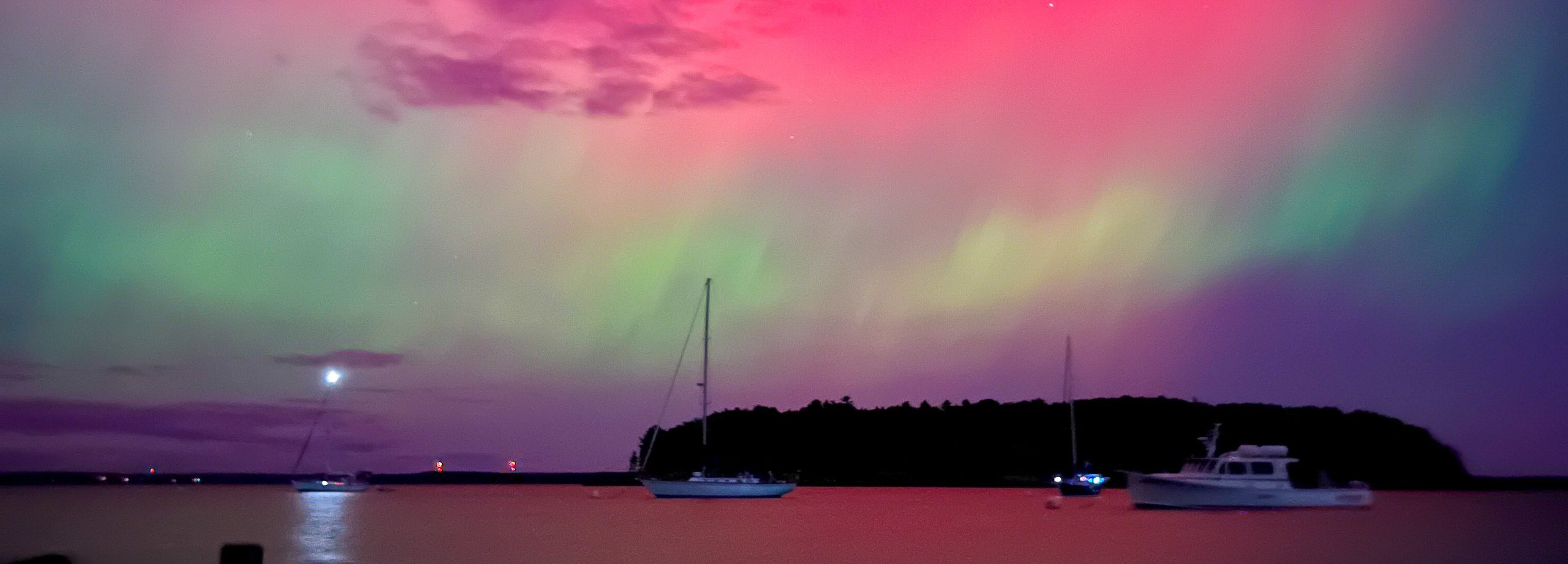 Northern lights over water and island 