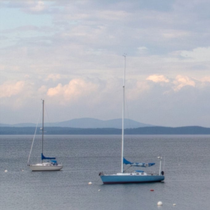 Two sailboats on calm water