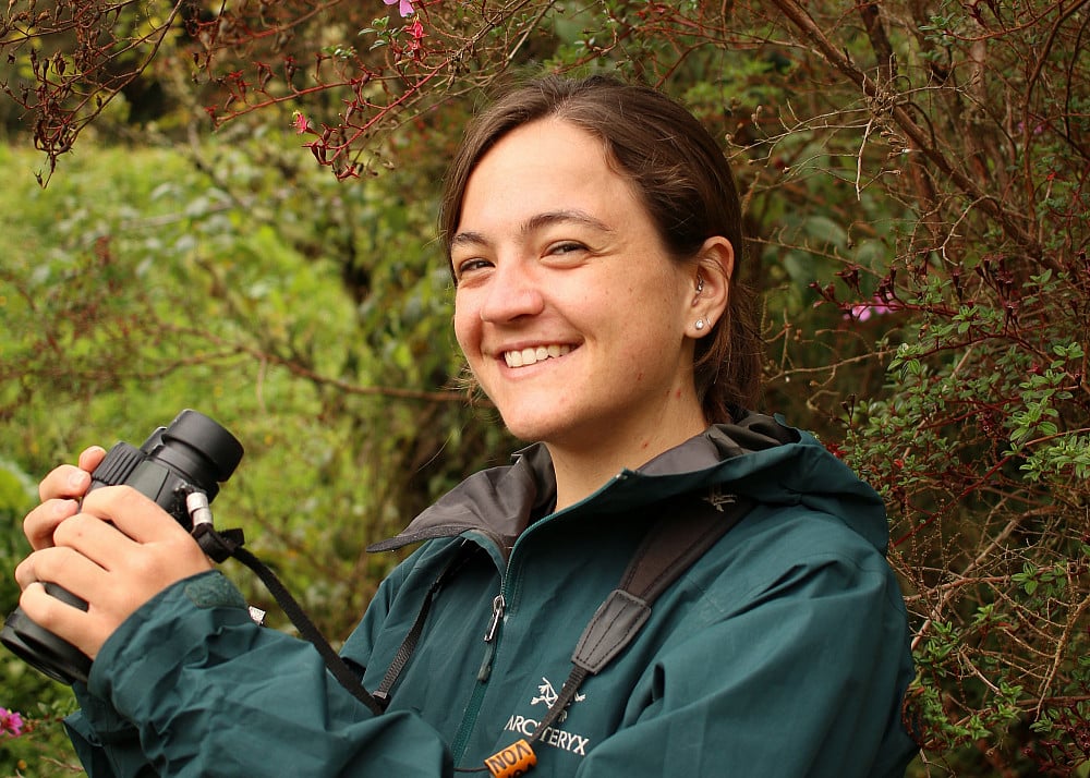 Person holding camera in nature.