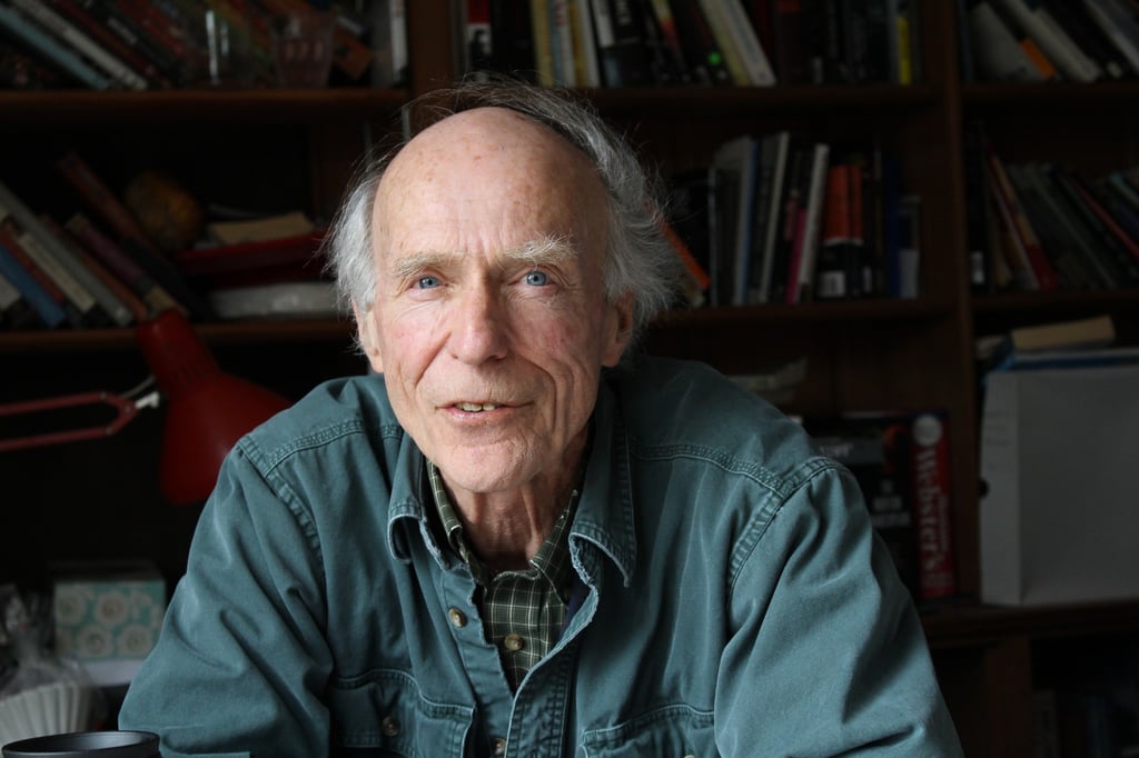 bill headshot with bookshelf in background