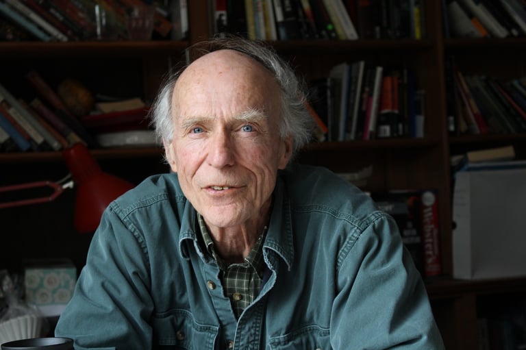 bill headshot with bookshelf in background