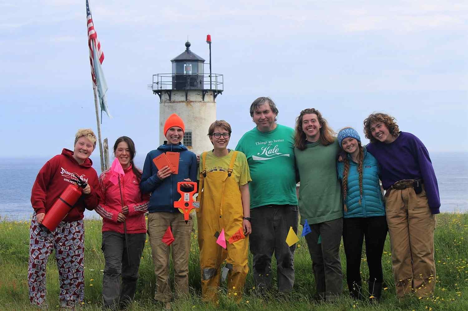 Group of people near lighthouse.