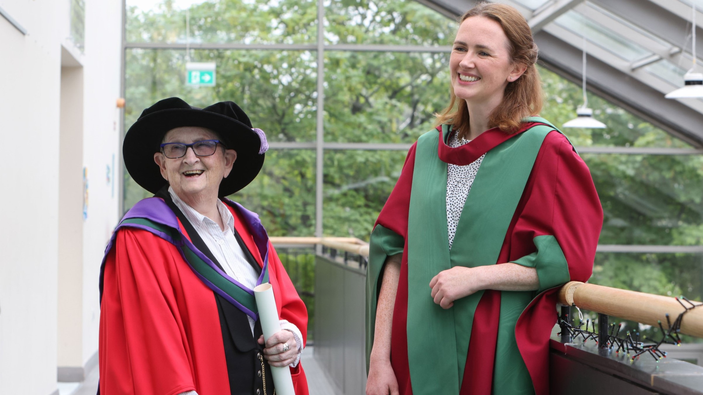 two people in graduation regalia