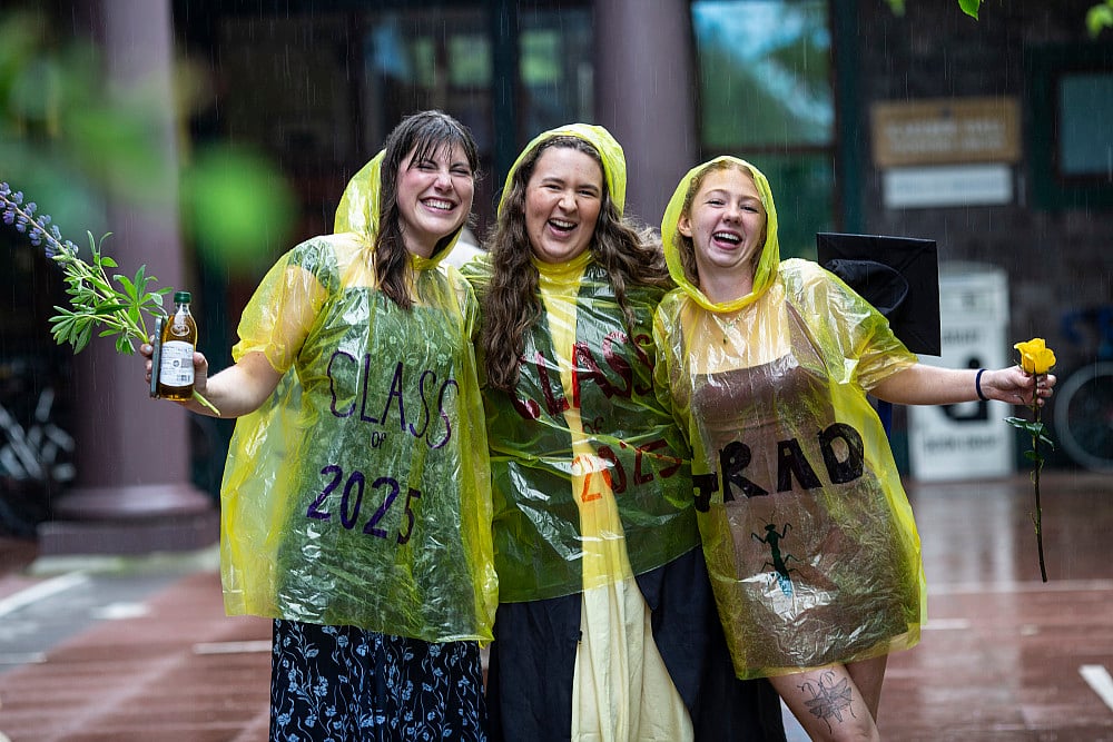 Graduates celebrating in rain ponchos.